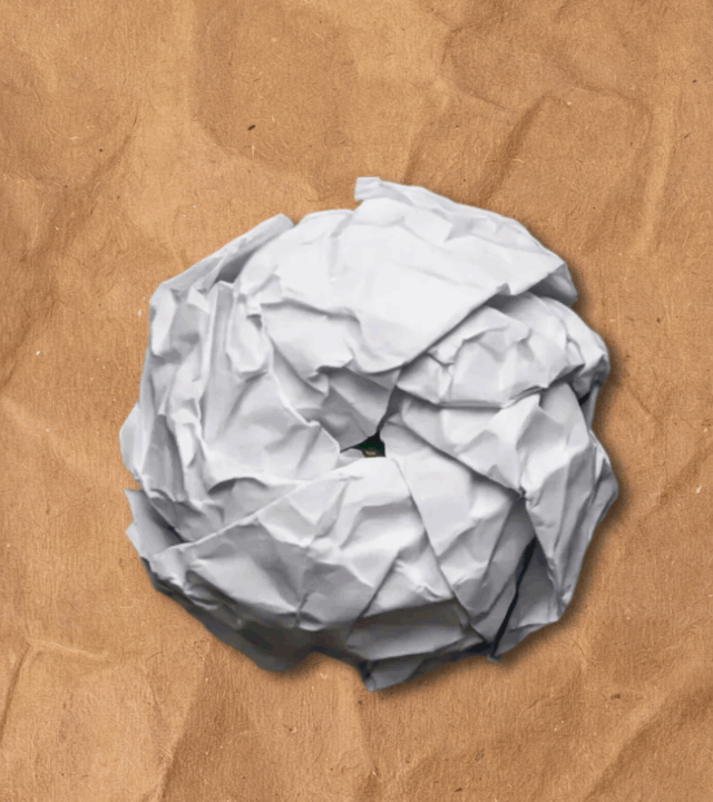 A crumpled paper ball unfolding into a cat sticker